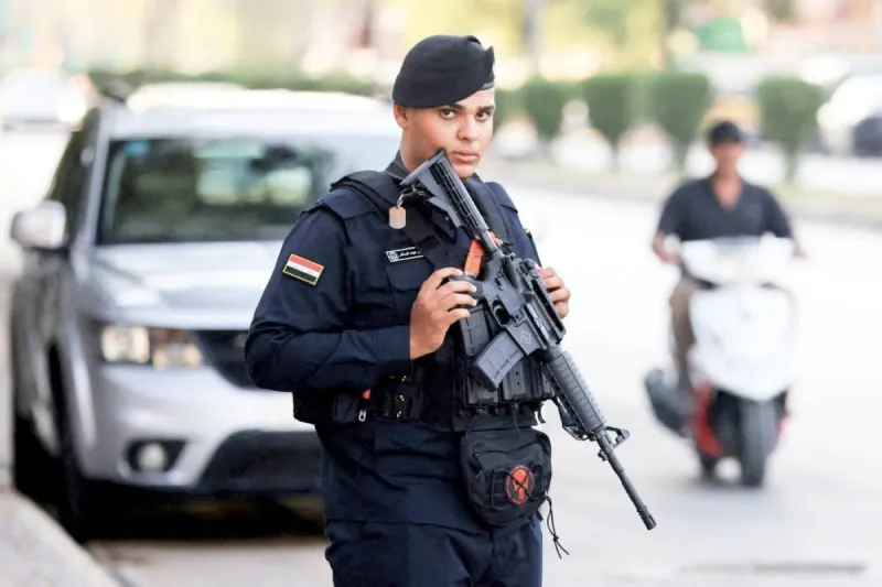 Armed fighters affiliated with Iran-backed militias in Iraq, representing the challenge of loose weapons facing the new Iraqi government.