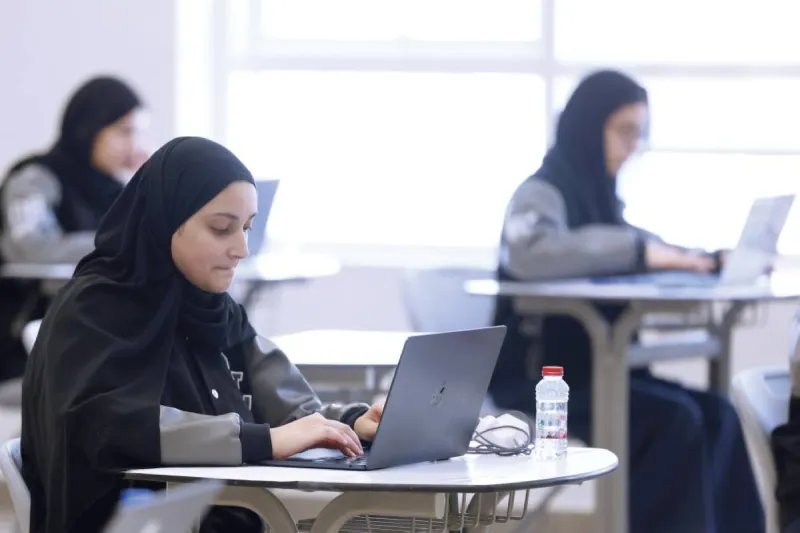 Grade 12 students sitting the Islamic Education end-of-year examination in an organised school hall in the UAE.