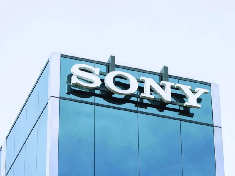 A PlayStation game disc alongside a PlayStation console, illustrating Sony's announcement to phase out physical game discs by 2028.