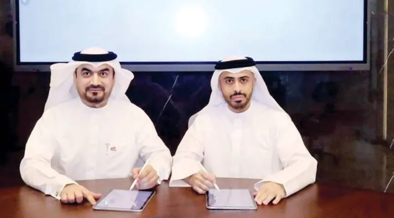 Officials from the Sheikh Zayed Housing Programme and e& Group exchange a signed cooperation agreement during a formal ceremony.