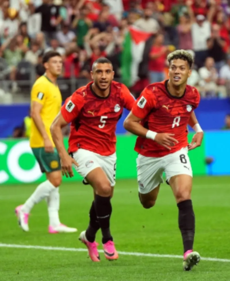 Imam Ashour celebrating after scoring a goal for the Egyptian national team at the 2026 FIFA World Cup.