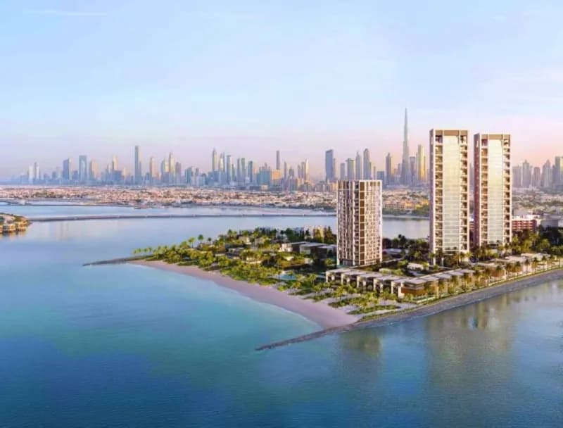 An aerial view of Peninsula Island, a waterfront luxury development in Jumeirah 2, Dubai, featuring marina residences and contemporary architecture.