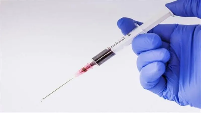 A researcher works with laboratory equipment in a study related to tuberculosis vaccine development.