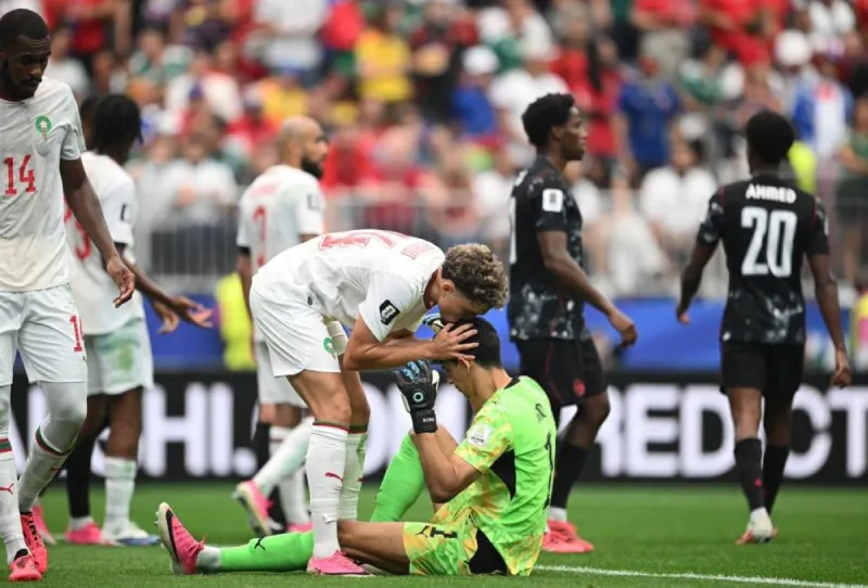 Moroccan goalkeeper Yassine Bono in action during Morocco's World Cup match, commanding his penalty area against Canada.