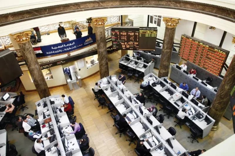 An electronic board displays stock market indices across Arab exchanges, with figures showing mixed trading performance across the Gulf region and beyond.