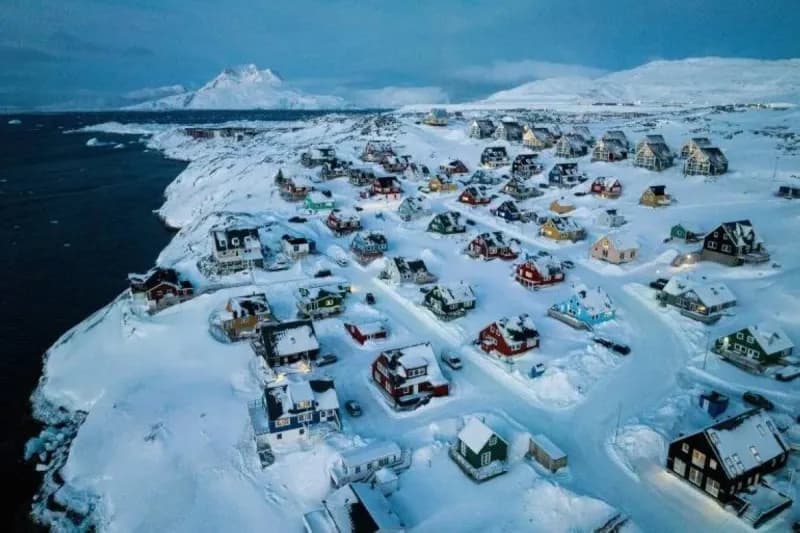 An aerial view of Greenland's ice-covered coastline, illustrating the Arctic island at the centre of US acquisition discussions.