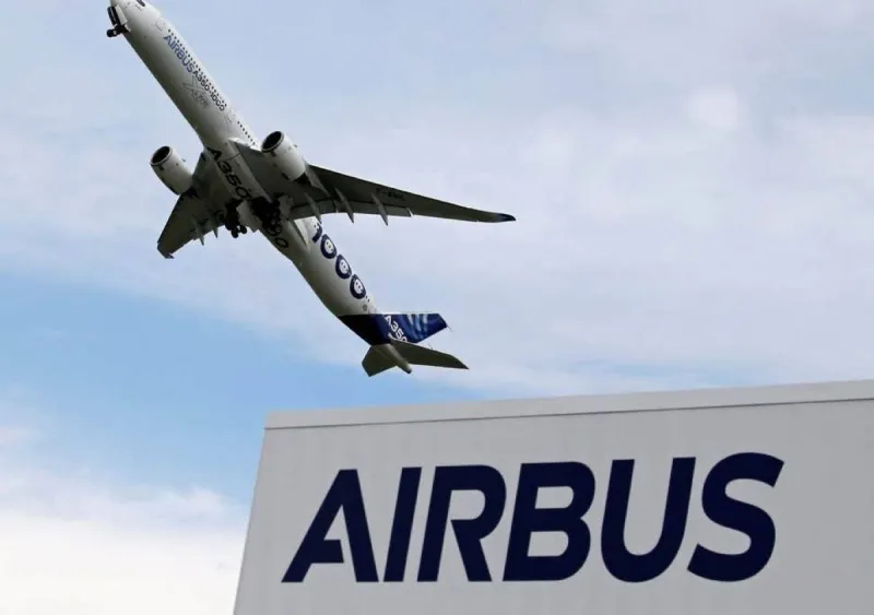 An Airbus commercial aircraft on a runway, illustrating the manufacturer's record delivery targets for the year.