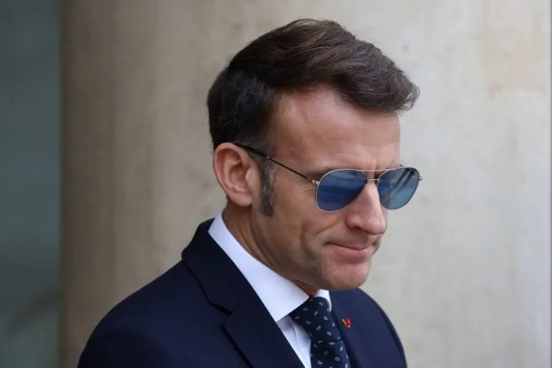 French President Emmanuel Macron wearing sunglasses during his official visit to Damascus.