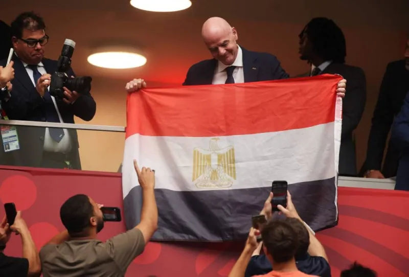 FIFA President Gianni Infantino holds up Egypt's flag before the Colombia vs Switzerland round-of-16 match at the 2026 FIFA World Cup.