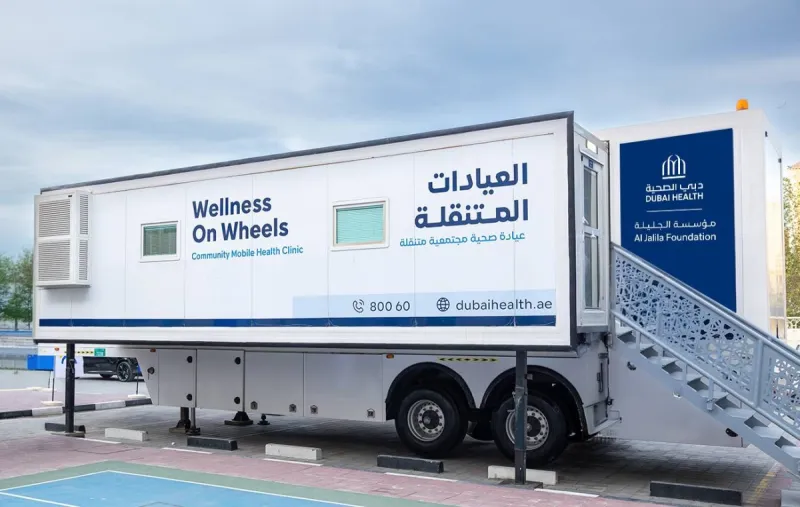 A mobile clinic unit operated by Al Jalila Foundation providing free health screenings to community members at a residential location in Dubai.