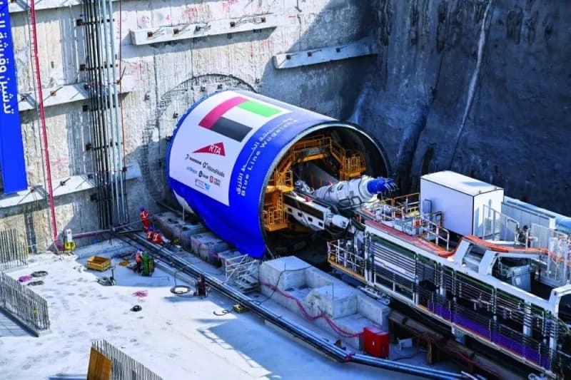 A giant tunnel boring machine underground during excavation works for the Dubai Metro Blue Line project.",