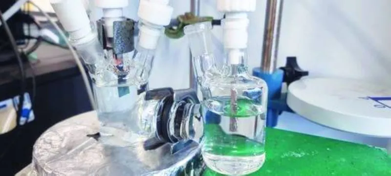 Scientists working on a process to convert captured carbon dioxide and hydrogen emissions into ethanol in a laboratory setting.