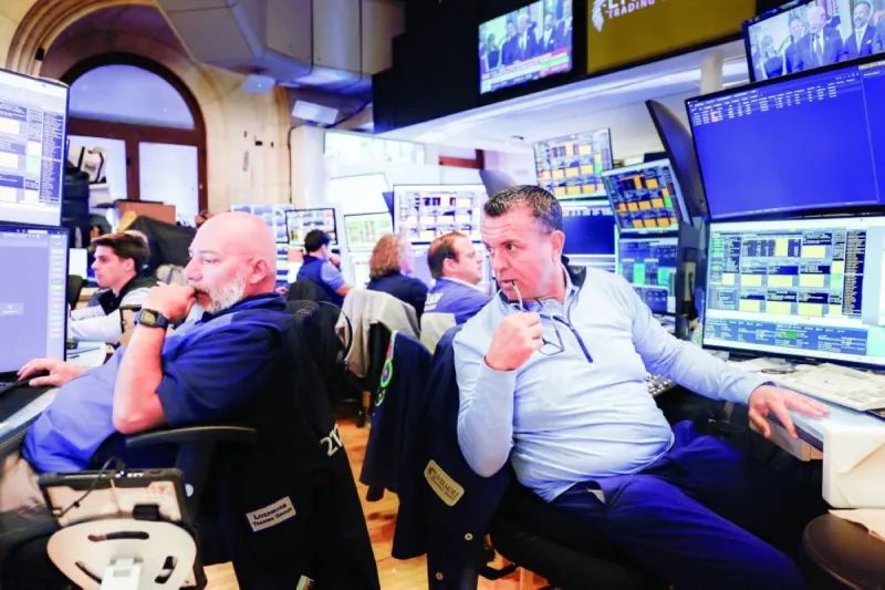 A trading floor screen displays global stock market indices reflecting gains in technology and semiconductor sectors amid geopolitical tensions.