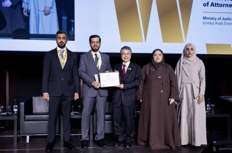 A representative of the UAE Ministry of Justice receives an international award at a ceremony held in Geneva during the World Summit on the Information Society and the AI for Good Forum.