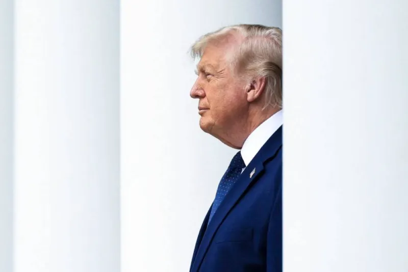 US President Donald Trump speaking during a television interview, with imagery related to Iran's nuclear programme in the background.