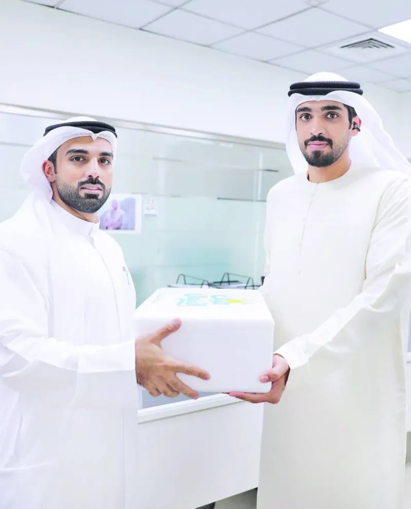 Sharjah Department of Public Works staff receiving summer refreshments during the 'Summer of Public Works' initiative.