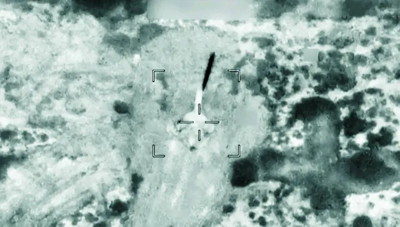Warships and commercial tankers navigating the Strait of Hormuz amid heightened military tensions between Iran and the United States.