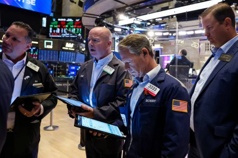 A display board showing declining figures for major US stock market indices including the Dow Jones, Nasdaq, and S&P 500.
