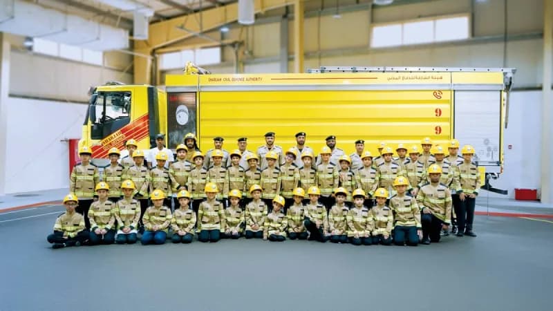Children in firefighter gear participating in the 'Little Firefighter' programme at the Fire and Rescue Centre in Sharjah's Al Malha area.