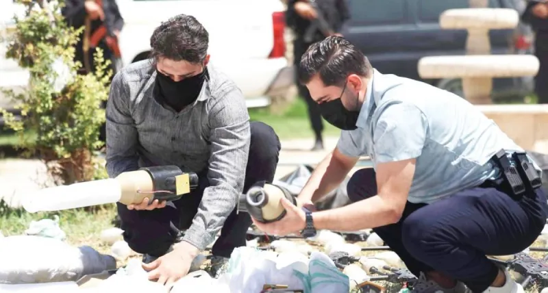 Syrian border security forces inspect a seized weapons shipment intercepted at the Al-Tanf border crossing with Iraq.
