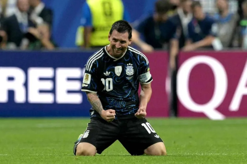Lionel Messi in action during a World Cup final match, wearing Argentina's national team kit.